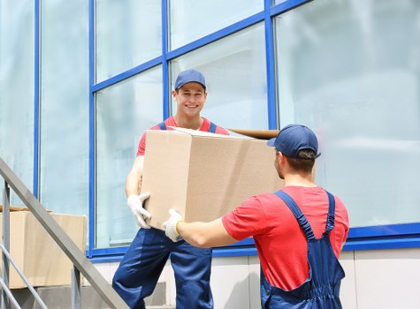 Supervisor reviewing safety procedures near a removal van