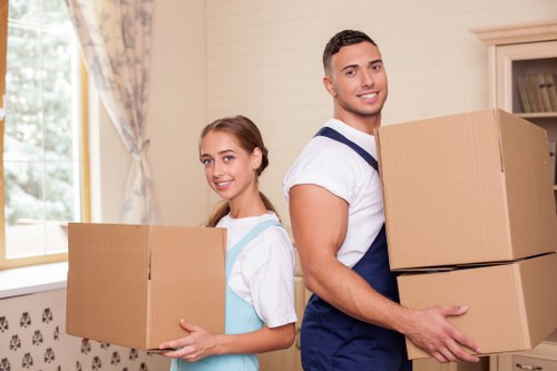 Professional movers carrying boxes during a Pimlico same day relocation
