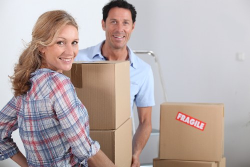 Movers carefully navigating a piano through a Pimlico property
